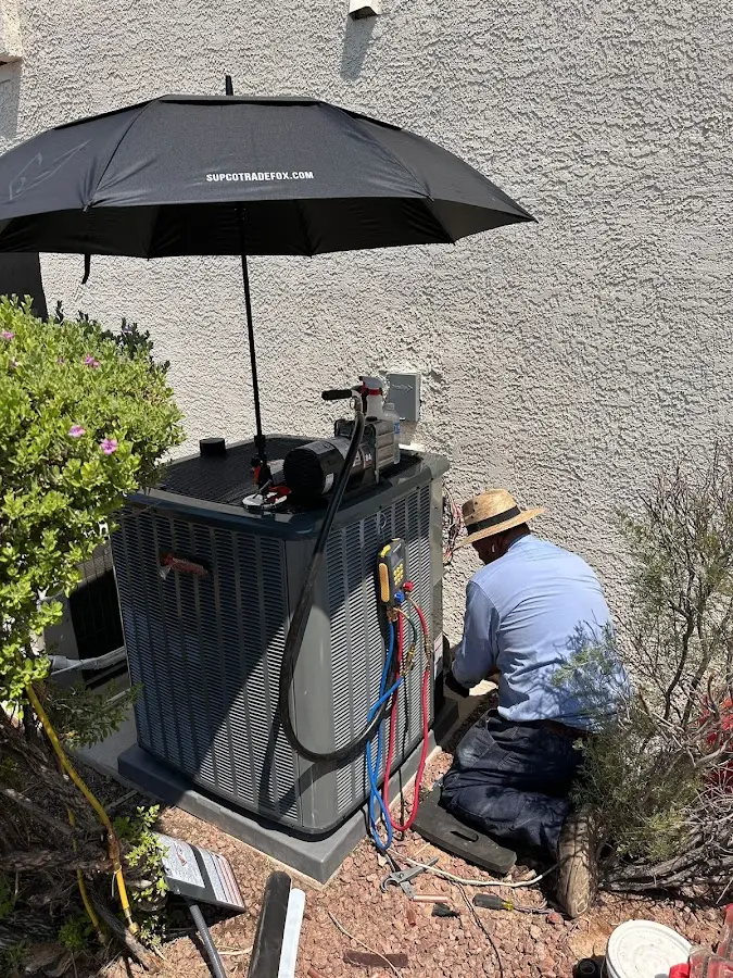HVAC technician performing outdoor AC maintenance in El Cerrito